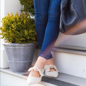 Oat color slip-on mule with an adjustable bow